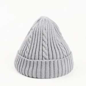 Detail view of light grey cable knit beanie with premium ribbed edge and warm wool texture
