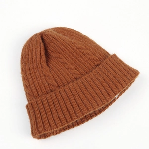 Detail view of caramel brown cable knit beanie with thick ribbed cuff texture