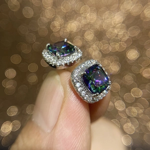 Macro view of square iridescent mystic topaz stud earrings with halo cubic zirconia