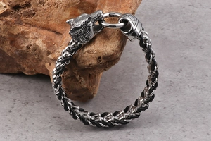 Macro detail of viking wolf head clasp on premium black braided leather bracelet