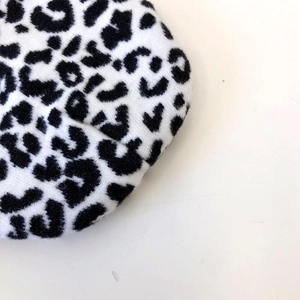 Close-up of black and white leopard print knitted beanie with soft texture detail