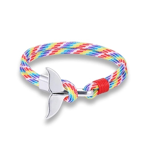 Close-up of rainbow braided paracord bracelet with a silver whale tail metal buckle