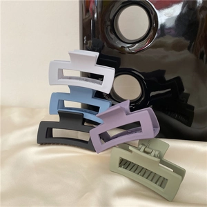 Detailed shot of matte rectangular hair claws in various Morandi colors like grey and blue