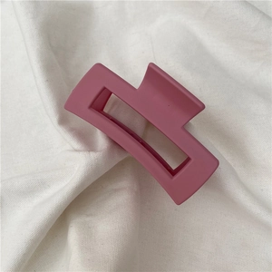Detail of matte Morandi purple rectangular hollow hair claw clip on linen fabric