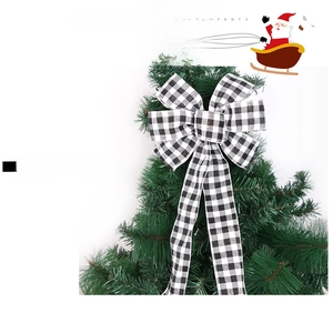 Detail of a large black and white plaid polyester bow used as a Christmas tree decoration