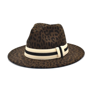 Detailed view of leopard print fedora hat featuring a striped decorative ribbon band