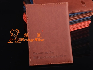 Detail of stacked PU leather passport covers with contrast stitching and embossed text