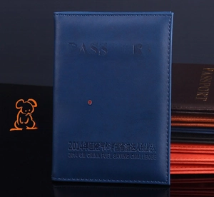 Detail view of navy blue PU leather passport holder with precise stitching and embossed logo