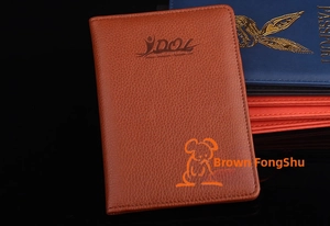 Detail showing various colors of PU leather passport covers with lychee texture and logo