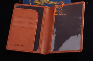 Close-up of brown pebbled leather passport holder with multi-card slots and inner pocket