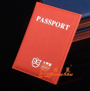 Detail of orange PU leather passport holder with embossed text and fine stitching