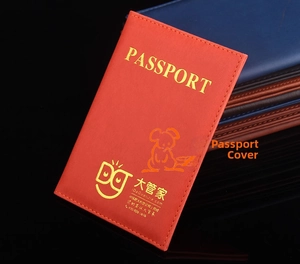 Close-up of red PU leather passport holder with gold lettering and stitch details