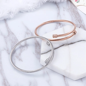 Minimalist stainless steel twisted cable bangles in silver and rose gold finishes