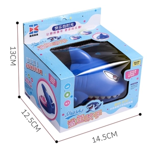 Detail view of blue shark biting toy showing product dimensions and colorful box packaging