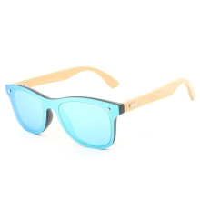 Detail of colorful blue mirror lenses and natural bamboo temples on trendy sunglasses