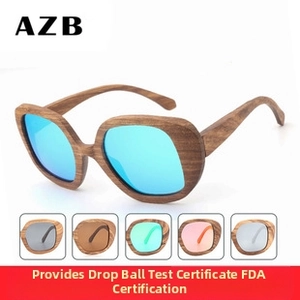 Detail of bamboo wood sunglasses featuring blue mirrored lenses and natural wood grain finish