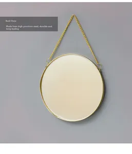 Detail view of the durable high-precision gold steel frame on the back of the round wall mirror