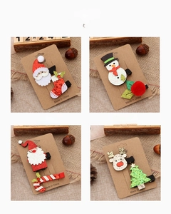 Detailed four-style view of glittery Christmas hair clips featuring reindeer and Santa