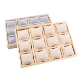 Macro detail of wooden 12-slot watch tray with premium soft fabric cushions