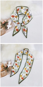 Detail showing floral pattern skinny silk scarf tied with elegant green border