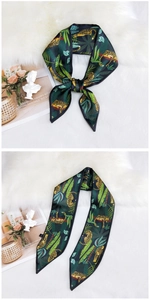 Detailed view of a green leopard print twilly silk scarf tied in a bow on faux fur
