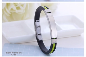 Detail of black silicone sports bracelet with neon yellow line and steel buckle clasp