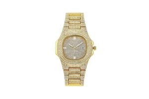 Macro view of gold metal watch case with sparkling crystal setting and date display