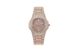 Macro detail of rose gold watch with crystal encrusted dial and calendar display