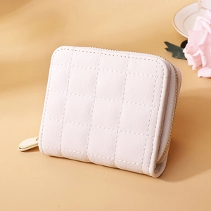Detail of light pink mini wallet with diamond quilted stitching and gold zipper