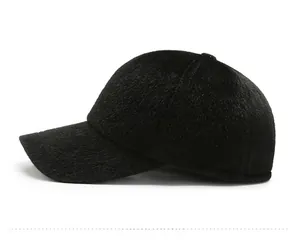 Close-up of black faux fur winter cap with silver Sport logo and warm fluffy texture