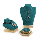 Detail of dark green velvet necklace bust and wooden jewelry display stand set