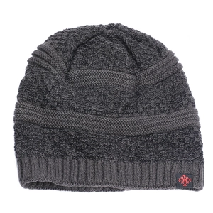 Detail view of the ribbed knit cuff and red snowflake logo on this dark grey winter beanie
