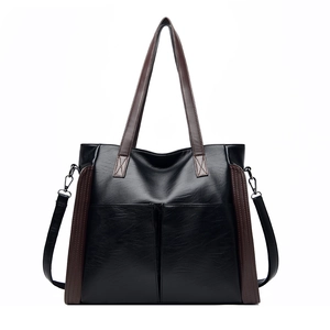 Large capacity black faux leather tote bag with brown contrast straps and twin front pockets
