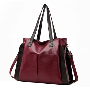 Large soft leather tote bag in burgundy and brown contrast with pebble texture