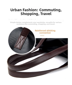 Detail of cross-stitch reinforced handle connection on black litchi leather tote bag
