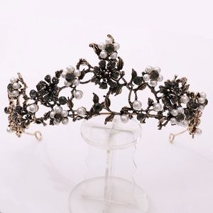 Detail of Baroque floral crown with white pearls and black rhinestones on gold metal