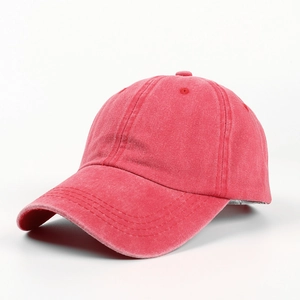 Close-up of red washed cotton baseball cap showing vintage texture and curved brim