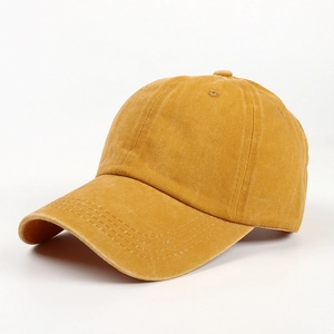 Detail of a mustard yellow baseball cap showing reinforced stitching and cotton fabric texture