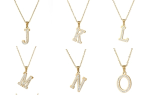 Detailed close-up of 18k gold plated alphabet pendants with cubic zirconia micro-pave