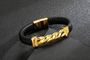 Close-up of black braided leather bracelet with golden twisted stainless steel accents