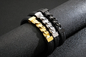 Macro shot of men's braided leather bracelets with twisted metal in gold, silver and black
