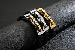 Detailed close-up of woven leather bracelets with gold and silver titanium steel clasps