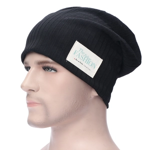 Classic black ribbed knit beanie with a white woven fashion label for casual winter wear