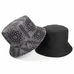 Detailed view of paisley pattern stitching and fabric texture on two bucket hats