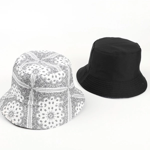Double-sided paisley bucket hat in black and white bohemian floral prints for sun protection
