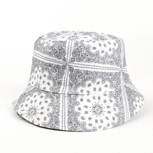 Close-up of black and white paisley pattern on cotton bucket hat with flat crown detail