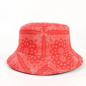 Detailed view of red paisley bucket hat with white bandana print on durable cotton fabric