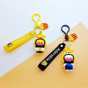 Close-up of cute cartoon duck keychains in yellow and black with Adorable straps