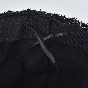 Detail of sequin beret showing black lining and adjustable drawstring for custom fit