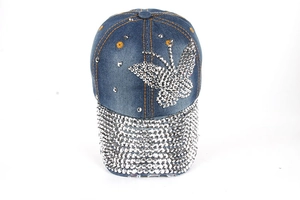 Denim baseball cap featuring large rhinestone butterfly and studded brim on blue wash fabric